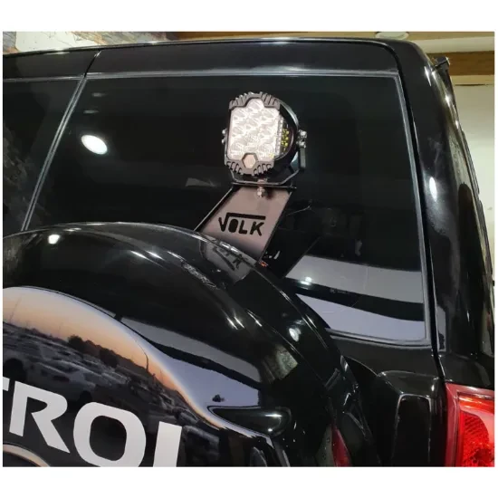 Flag and searchlight base behind a Nissan Y61 spear